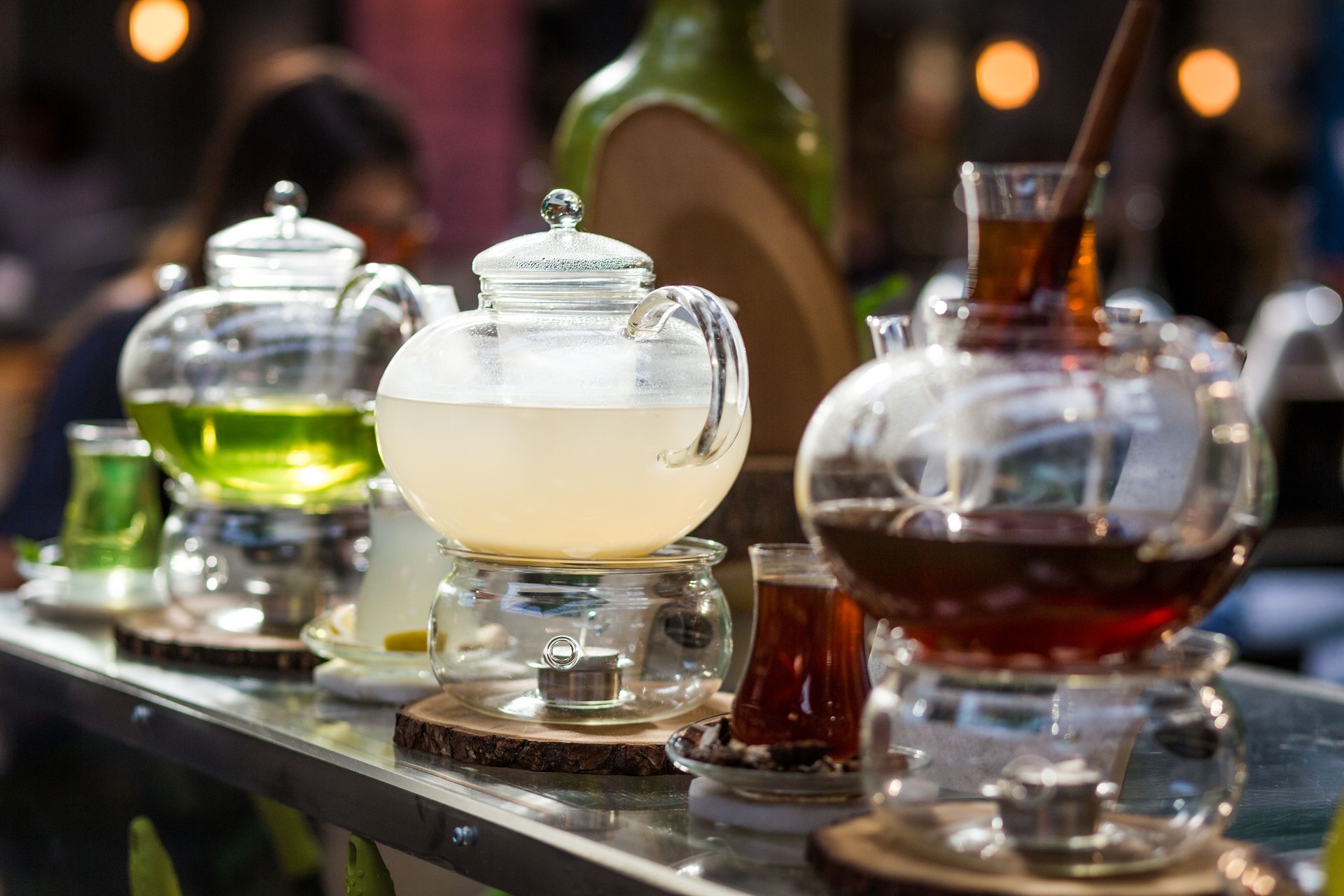 Selection of Freshly Brewed Tea Infused in Clear Glass Teapots